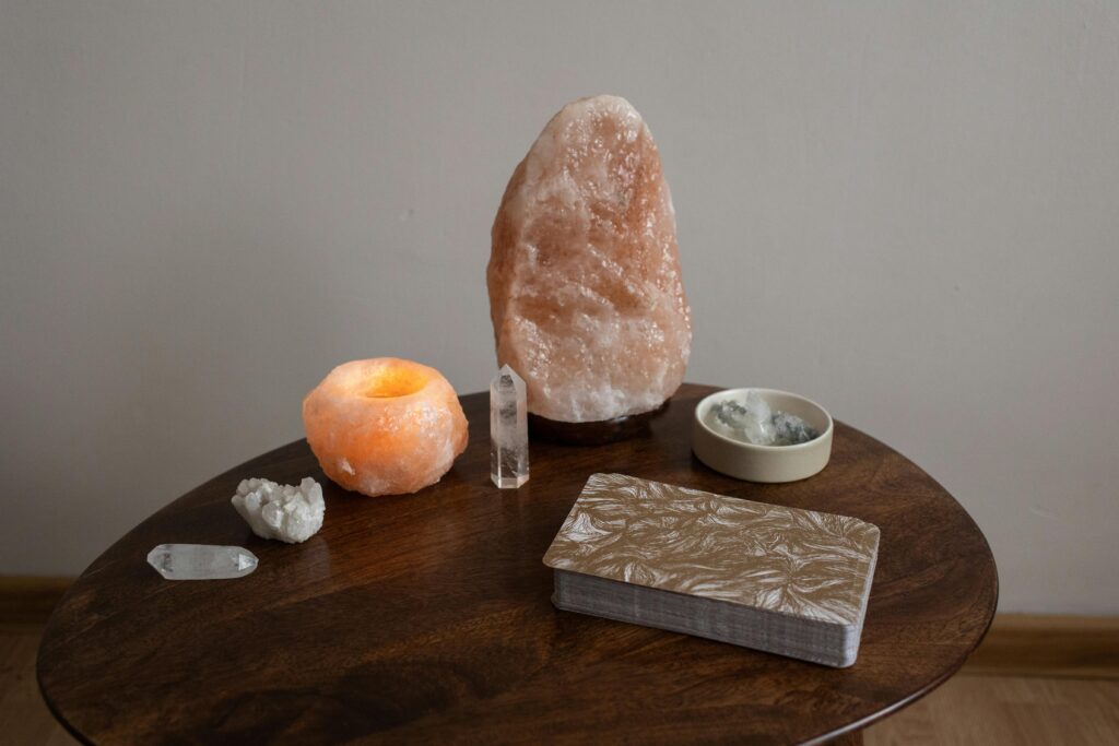 Crystals, stones, elixers, and tarot cards sit on a table for use in witchcraft