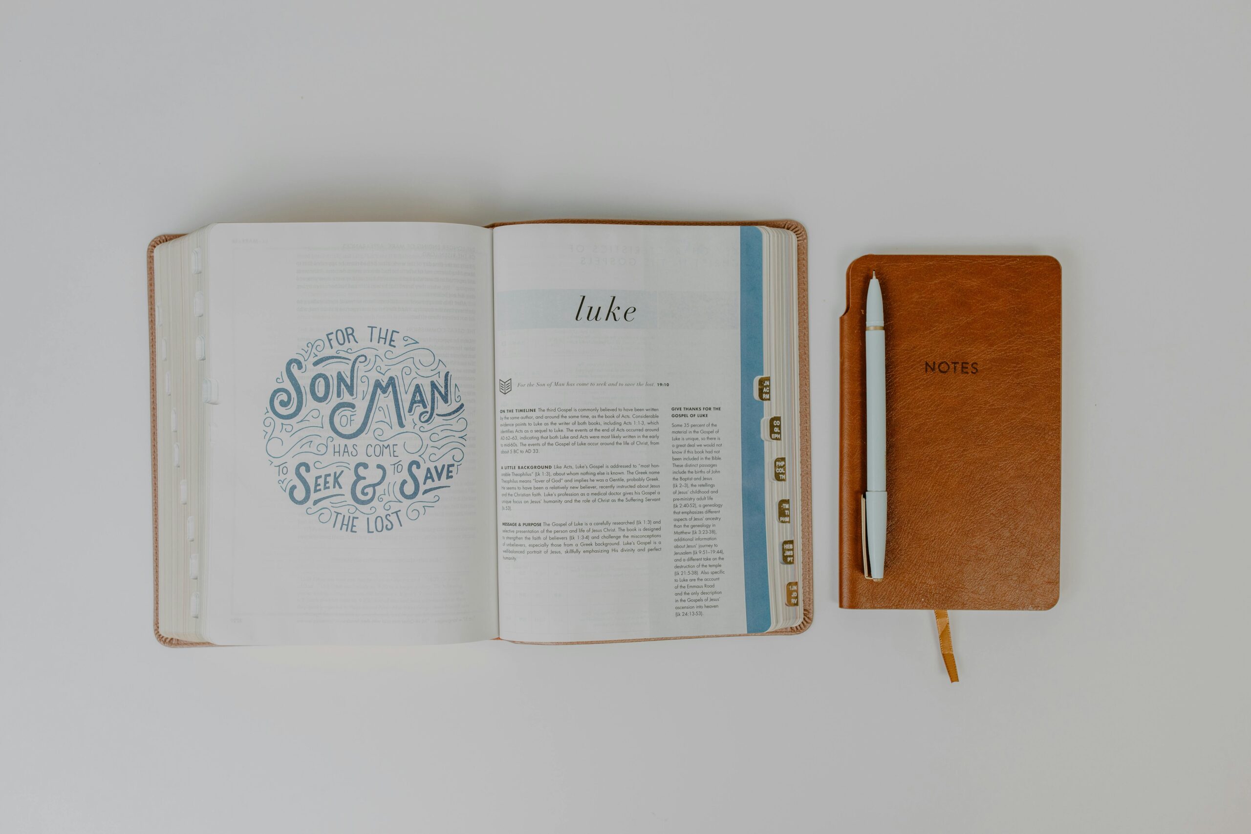 Bible is open with a journal sitting next to it with a pen in preparation to study